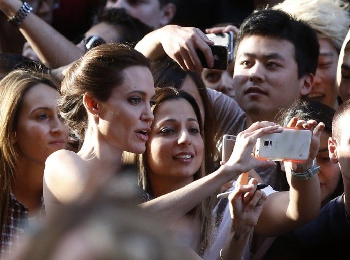 Angelina Jolie takes a selfie with fans at the world premiere of her film quotUnbrokenquot at the State Theatre in Sydney November 17, 2014. The war drama, based on the life of World War Two American prisoner of war Louis Zamperini, was produced and