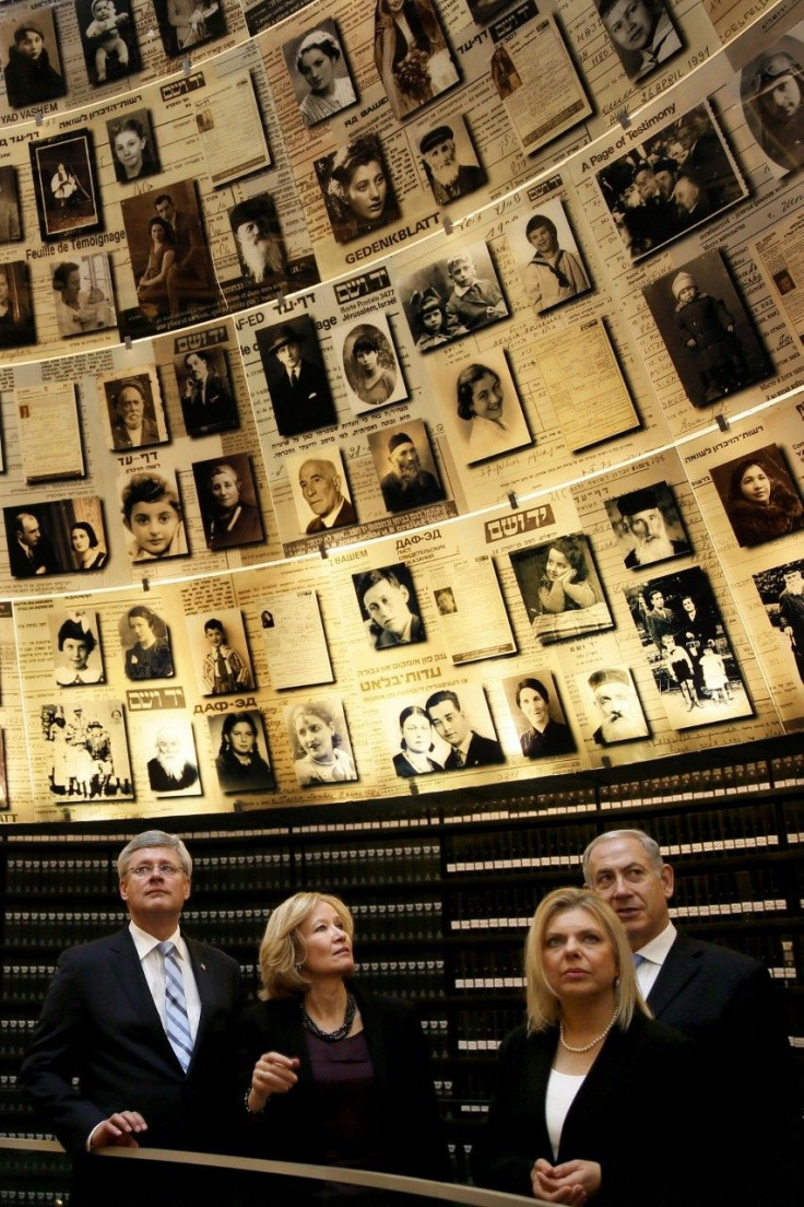 Canada's Prime Minister Stephen Harper (L) and his wife Laureen (2nd L), and Israel's Prime Minister Benjamin Netanyahu (R) and his wife Sara (2nd R), look at pictures of Jews killed in the Holocaust during a visit to the Hall of Names at Yad Va