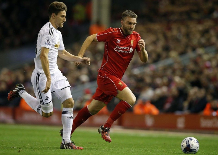 Liverpool&#039;s Rickie Lambert (R) is chased by Swansea City&#039;s Federico Fernandez during their English League Cup soccer match at Anfield in Liverpool, northern England, October 28, 2014.