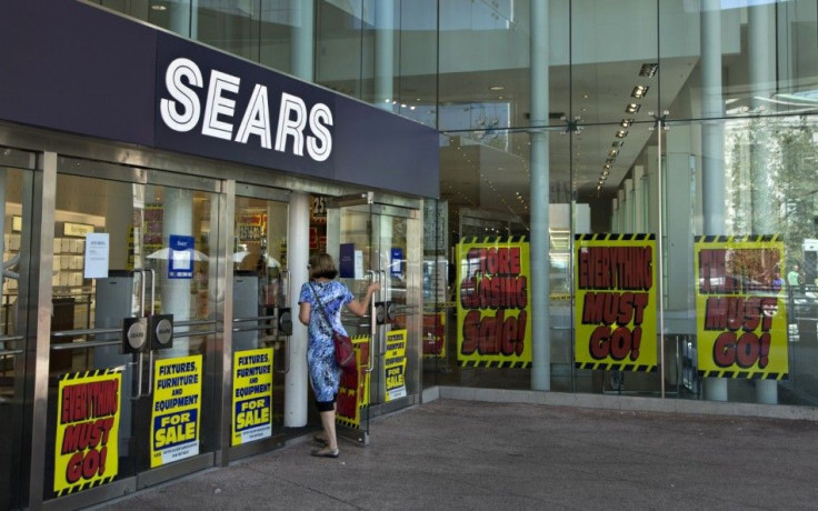 A customer enters the closing down Sears store 