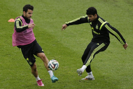Spain's Cesc Fabregas (L) controls the ball past teammate Diego Costa during a training session ahead of the 2014 World Cup in Curitiba, June 10, 2014.