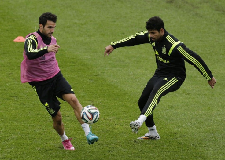 Spain's Cesc Fabregas (L) controls the ball past teammate Diego Costa during a training session ahead of the 2014 World Cup in Curitiba, June 10, 2014.