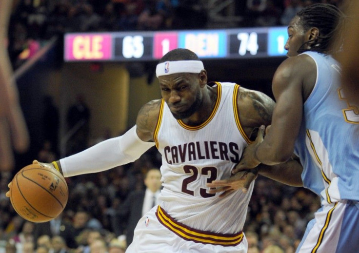 Nov 17, 2014; Cleveland, OH, USA; Cleveland Cavaliers forward LeBron James (23) drives on Denver Nuggets forward Kenneth Faried (35) during the fourth quarter at Quicken Loans Arena. The Nuggets beat the Cavaliers 106-97