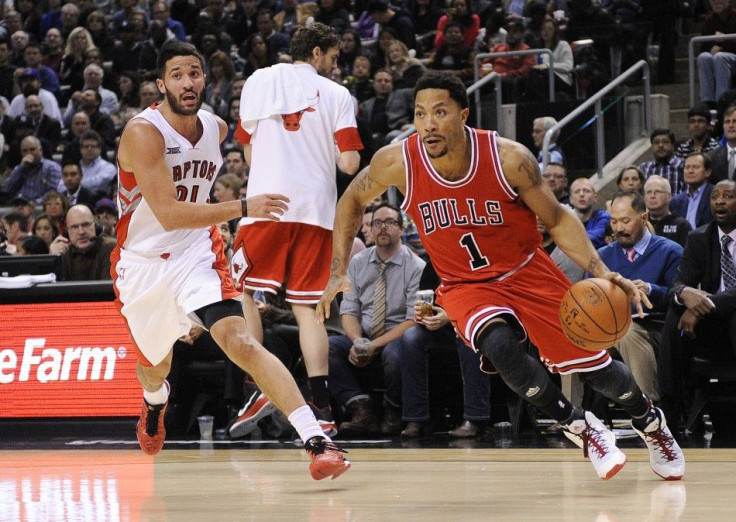 Chicago Bulls guard Derrick Rose (1) dribbles past Toronto Raptors |guard Greivis Vasquez (21) during the second period at Air Canada Centre. Chicago won 100 - 93.