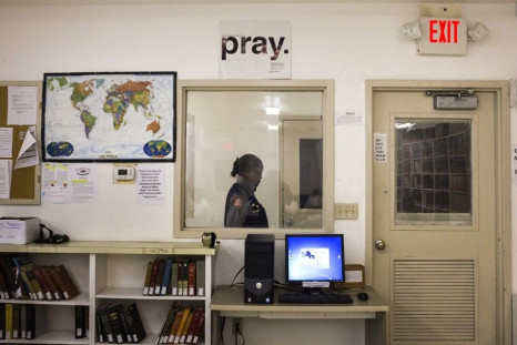 A security official walks past a sign seen inside a Southwestern Baptist Theological Seminary library located in the Darrington Unit of the Texas Department of Criminal Justice men's prison in Rosharon, Texas August 12, 2014. The Southwestern Baptist Theo