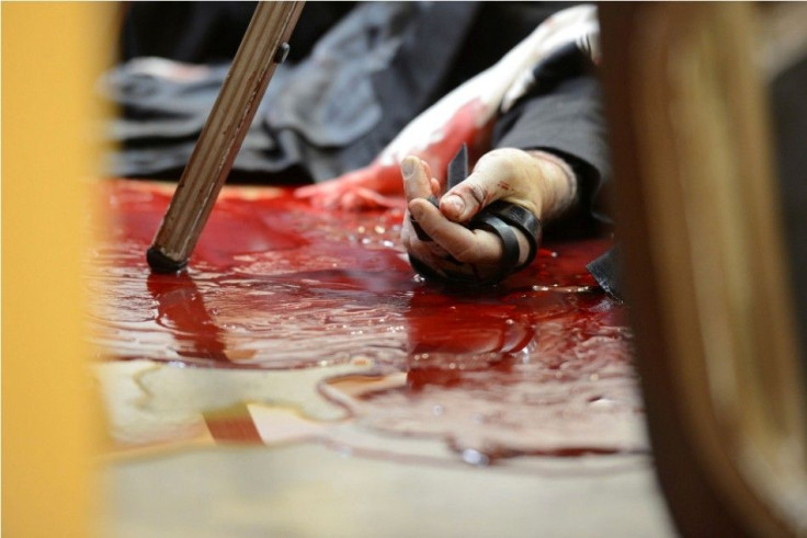 The body of a Jewish worshipper is seen at the scene of an attack at a Jerusalem synagogue