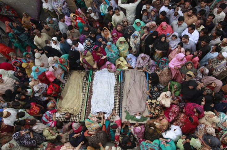 Relatives gather beside the bodies of victims who were killed in yesterday's suicide bomb attack on the Wagah border, before funeral prayers in Lahore November 3, 2014.