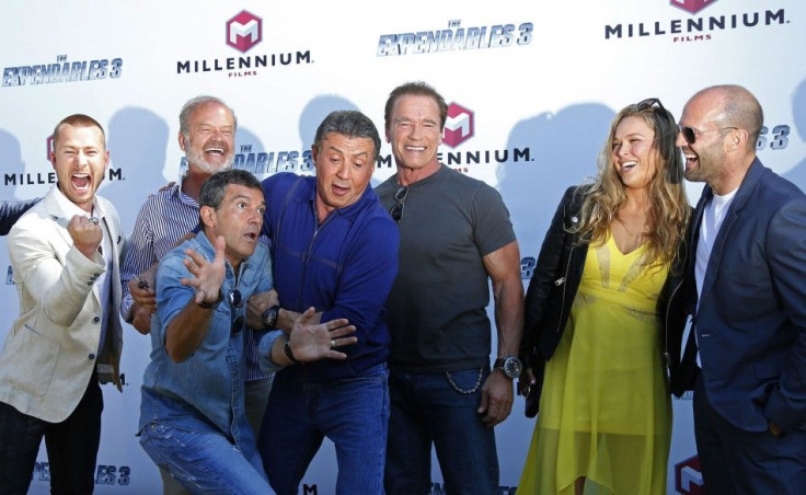 (L-R) 'The Expendables 3' Cast Members Glen Powell, Kelsey Grammer, Antonio Banderas, Sylvester Stallone, Arnold Schwarzenegger, Ronda Rousey And Jason Statham