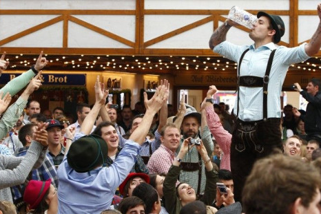Visitors enjoy beer during their visit to the 181st Oktoberfest in Munich September 28, 2014. Millions of beer drinkers from around the world will come to the Bavarian capital for the Oktoberfest, which runs until October 5. REUTERS/Michaela Rehle