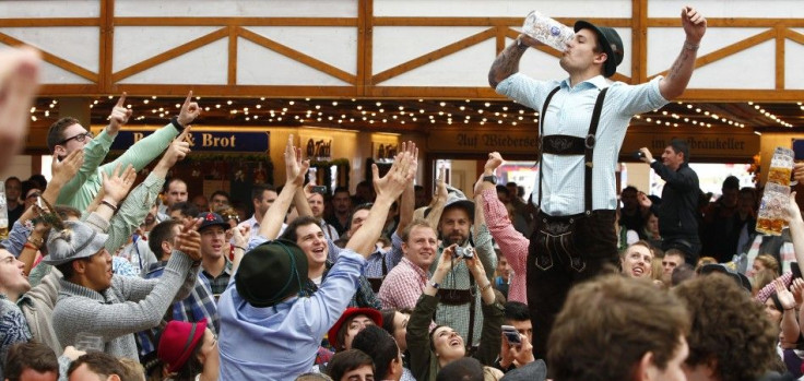 Visitors enjoy beer during their visit to the 181st Oktoberfest in Munich September 28, 2014. Millions of beer drinkers from around the world will come to the Bavarian capital for the Oktoberfest, which runs until October 5. REUTERS/Michaela Rehle