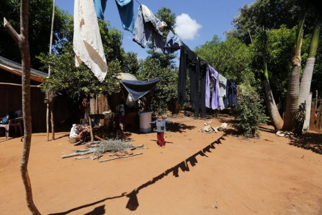 A boy stands near laundry hanging outside his home in Doctor Juan Leon Mallorquin March 13, 2014. Poverty affects nearly 40 percent of the Paraguayan population and is concentrated in sub-urban areas and in the rural sector.