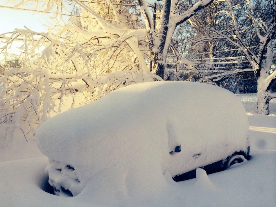 A car is covered in snow in Orchard Park outside of Buffalo, New York, November 19, 2014. Western New York state braced for a fresh wave of heavy snow on Wednesday after a freakish storm swept off the Great Lakes and buried the region under 5 feet 1.5 me