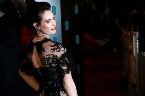 Actress Lily James poses as she arrives for the British Academy of Film and Arts (BAFTA) awards ceremony