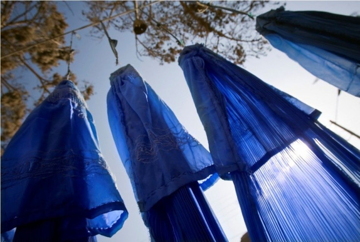 Burqas are displayed in front of a shop