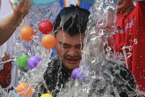 Men dump buckets of ice water and plastic balls onto former NBA player Yao Ming as Yao takes part in the ALS ice bucket challenge in Beijing August 23, 2014. The Ice Bucket Challenge is aimed at raising awareness of - and money to fight - Amyotrophic Late