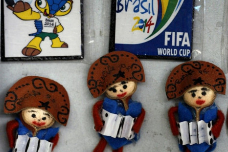 Handcrafted dolls are displayed next to World Cup souvenir magnets in a store at Sao Jose Municipal Market in Recife, northeastern Brazil April 5, 2014. Recife is one of the host cities for the 2014 World Cup in Brazil.