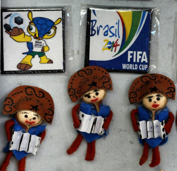 Handcrafted dolls are displayed next to World Cup souvenir magnets in a store at Sao Jose Municipal Market in Recife, northeastern Brazil April 5, 2014. Recife is one of the host cities for the 2014 World Cup in Brazil.