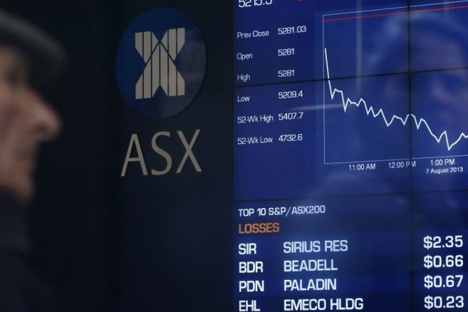 A man looks the board of the Australian Securities Exchange in central Sydney August 7, 2013. Australian shares skidded 1.3 percent on Wednesday, its biggest fall in five weeks, hit by sharp falls in miners and financials as regional markets tracked a sof
