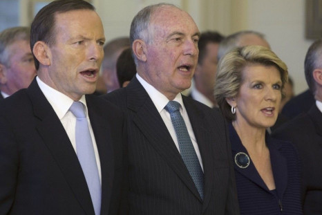 The new Prime Minister of Australia Tony Abbott, Deputy Prime Minister Warren Truss and Foreign Minister Julie Bishop sing the national anthem before the official swearing in of government ministers at the Government House in Canberra September 18, 2013. 