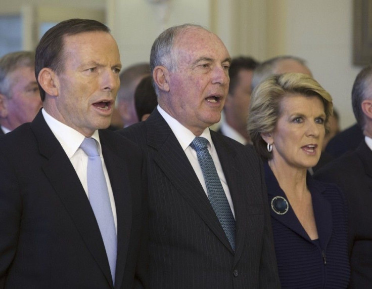 The new Prime Minister of Australia Tony Abbott, Deputy Prime Minister Warren Truss and Foreign Minister Julie Bishop sing the national anthem before the official swearing in of government ministers at the Government House in Canberra September 18, 2013. 