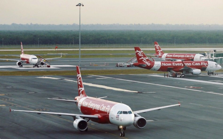 AirAsia planes are seen on the runway at Kuala Lumpur International Airport August 19, 2014. AirAsia Bhd, Asia's largest budget airline by passengers, said second-quarter net profit rose 529 percent due to foreign exchange gains, the deferment of tax