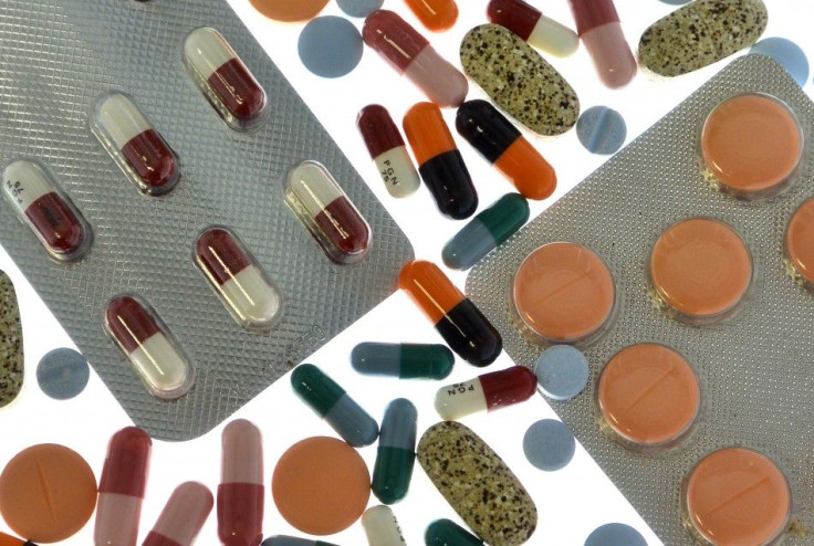 Pharmaceutical tablets and capsules in foil strips are arranged on a table in this picture illustration taken in Ljubljana September 18, 2013. Picture taken September 18. REUTERS/Srdjan Zivulovic