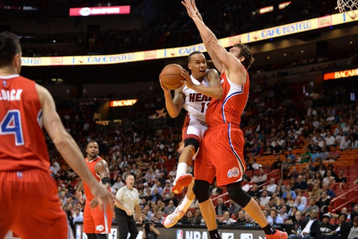 Nov 20, 2014; Miami, FL, USA; Miami Heat guard Shabazz Napier (13) drives to the basket as Los Angeles Clippers forward Spencer Hawes (10) defends the play during the second half at American Airlines Arena.