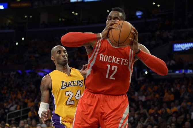 Los Angeles Lakers guard Kobe Bryant (24) is elbowed by Houston Rockets center Dwight Howard (12) during the second half at Staples Center.