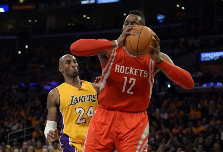 Los Angeles Lakers guard Kobe Bryant (24) is elbowed by Houston Rockets center Dwight Howard (12) during the second half at Staples Center.