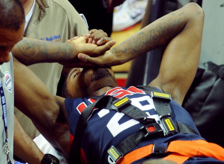 Aug 1, 2014; Las Vegas, NV, USA; Team USA guard Paul George is carted off the floor on a gurney after suffering a lower leg injury during the USA Basketball Showcase at Thomas & Mack Center.