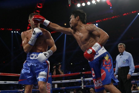 Manny Pacquiao (R) of the Philippines punches Chris Algieri of the U.S. during their World Boxing Organisation (WBO) 12-round welterweight title fight at the Venetian Macao hotel in Macau November 23, 2014.