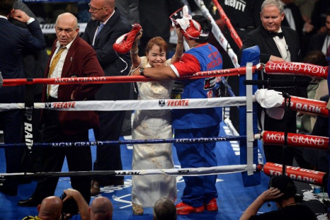 Apr 12, 2014; Las Vegas, NV, USA; Mother of Manny Pacquiao Dionesia Dapidran-Pacquiao holds up his gloves after the WBO World Welterweight Title bout against Timothy Bradley at MGM Grand Garden Arena. Pacquiao won via unanimous decision.