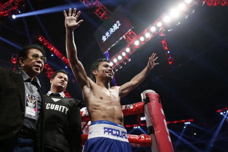 Manny Pacquiao of the Philippines celebrates his victory over Chris Algieri of the U.S. during their World Boxing Organisation (WBO) 12-round welterweight title fight at the Venetian Macao hotel in Macau November 23, 2014.