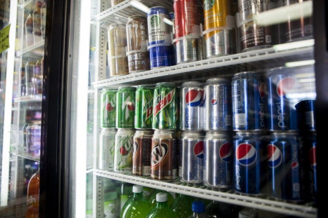 Cans of soda are displayed in a case at Kwik Stops Liquor in San Diego, California February 13, 2014.