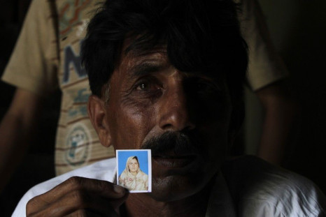 Muhammed Iqbal, 45, shows a picture of his late wife Farzana Iqbal, at his residence in a village in Moza Sial, west of Lahore May 30, 2014.