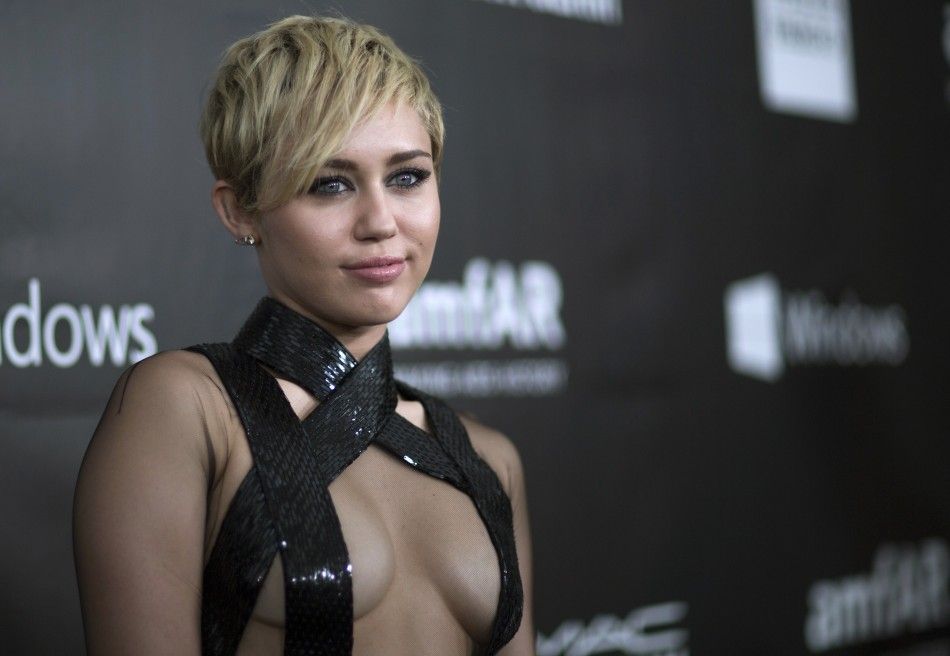 Singer Miley Cyrus poses at the amfARs Fifth Annual Inspiration Gala