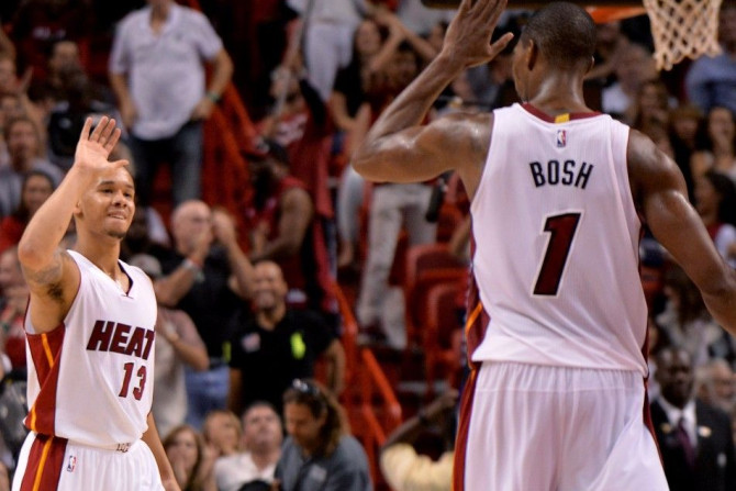 Nov 23, 2014; Miami, FL, USA; Miami Heat guard Shabazz Napier (left) is greeted by center Chris Bosh (right) after Napier made a three point basket against the Charlotte Hornets during the second half at American Airlines Arena. 94-93.