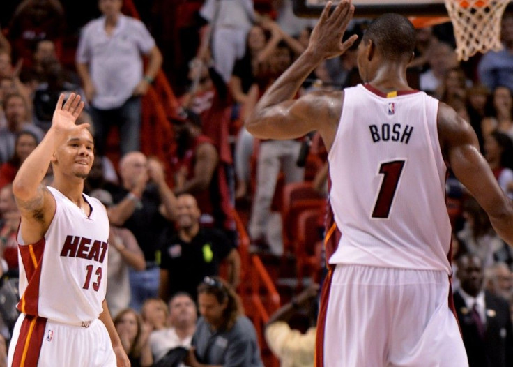 Nov 23, 2014; Miami, FL, USA; Miami Heat guard Shabazz Napier (left) is greeted by center Chris Bosh (right) after Napier made a three point basket against the Charlotte Hornets during the second half at American Airlines Arena. 94-93.