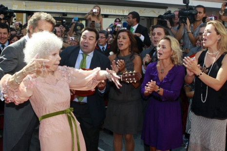 The Duchess of Alba dances flamenco beside her husband Alfonso Diez and music group &quot;Siempre Asi&quot; at the entrance of Las Duenas Palace after their wedding in Seville October 5, 2011.