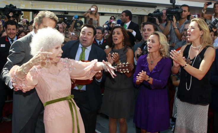 The Duchess of Alba dances flamenco beside her husband Alfonso Diez and music group &quot;Siempre Asi&quot; at the entrance of Las Duenas Palace after their wedding in Seville October 5, 2011.