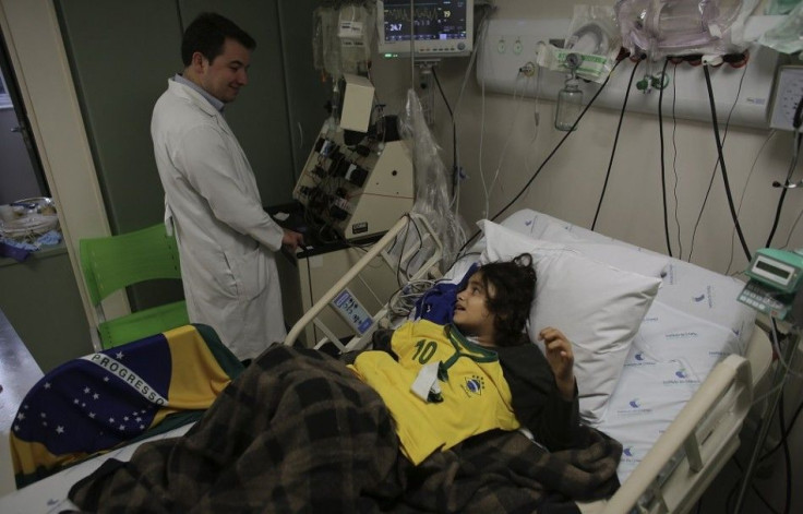 Brazilian patient Luana, 10, talks with her doctor before the 2014 World Cup Group A soccer match between Brazil and Mexico at the Cancer Itaci Hospital in Sao Paulo June 17, 2014.