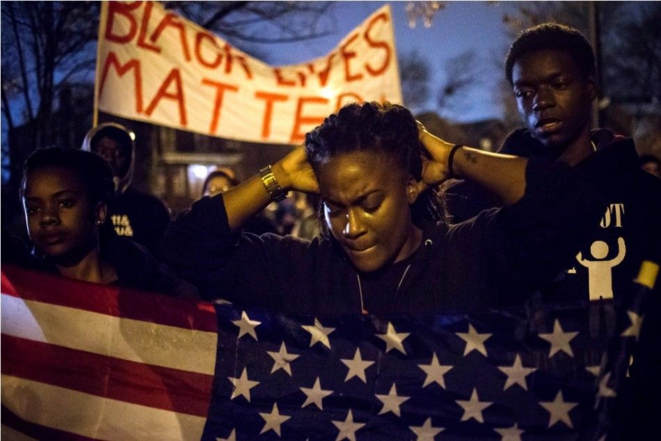Protesters, demanding the criminal indictment of a white police officer who shot dead an unarmed black teenager in August, march through a suburb in St. Louis, Missouri