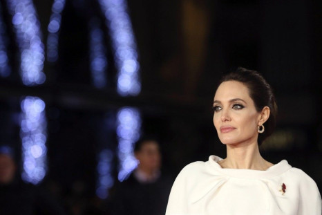 Angelina Jolie poses for a photograph as she arrives for the UK premiere of &quot;Unbroken&quot; in central London November 25, 2014.  REUTERS/Paul Hackett
