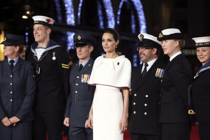 Angelina Jolie (C) poses for a photograph with members of the British armed forces as she arrives for the UK premiere of &quot;Unbroken&quot; in central London .  
