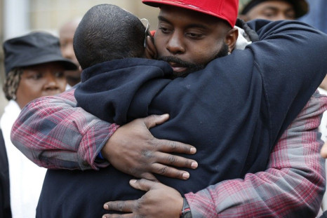 Michael Brown Sr. gets a hug at an annual Thanksgiving basket give away in St. Louis, Missouri, November 22, 2014. Prosecutors made preparations to announce the eventual decision on whether to indict police officer Darren Wilson in the Aug. 9 shooting of 