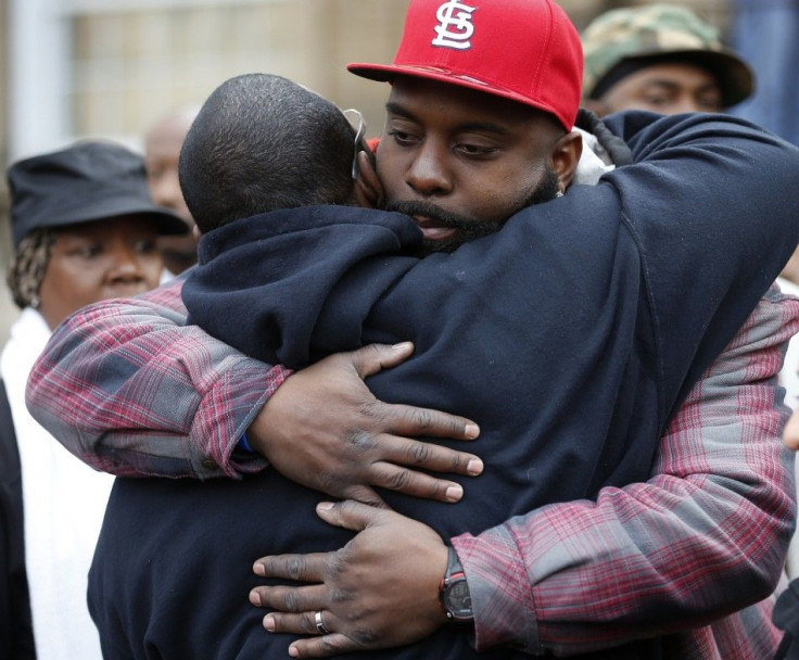 Michael Brown Sr. gets a hug at an annual Thanksgiving basket give away in St. Louis, Missouri, November 22, 2014. Prosecutors made preparations to announce the eventual decision on whether to indict police officer Darren Wilson in the Aug. 9 shooting of 