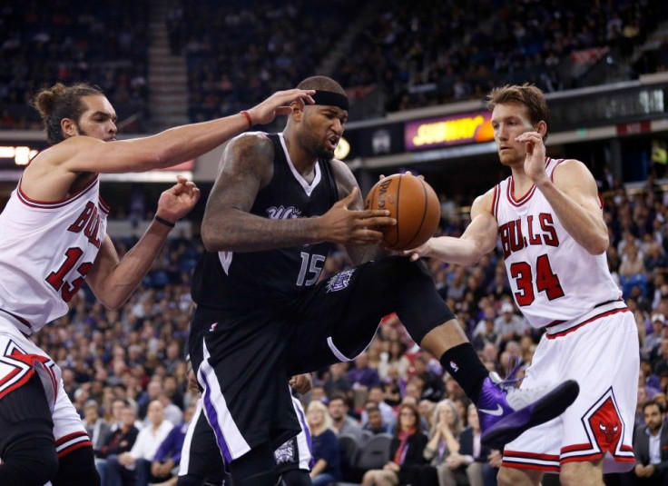 Nov 20, 2014; Sacramento, CA, USA; Sacramento Kings center DeMarcus Cousins (15) controls a rebound between Chicago Bulls center Joakim Noah (13) and forward Mike Dunleavy (34) during the fourth quarter at Sleep Train Arena. The Sacramento Kings defeated 