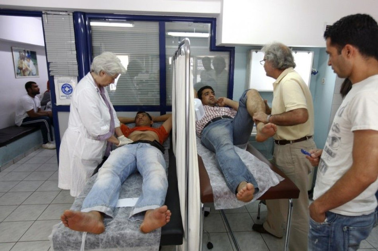 Doctors examine patients at a medical centre of the Greek delegation of the Doctors of the World in Athens May 31, 2012. Greece's rundown state hospitals are cutting off vital drugs, limiting non-urgent operations and rationing even basic medical material