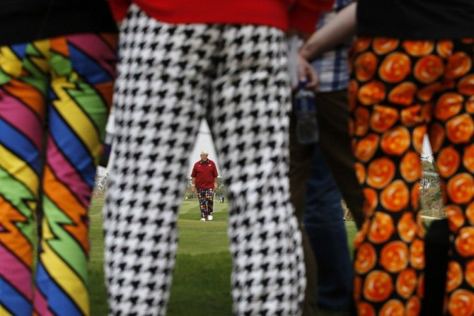 Spectators stand as John Daly of the U.S. walks on the 7th hole during the BMW Masters 2013 golf tournament at Lake Malaren Golf Club in Shanghai October 26, 2013.