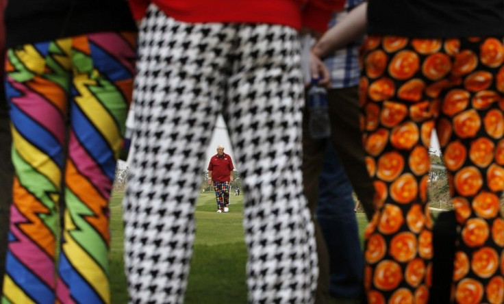 Spectators stand as John Daly of the U.S. walks on the 7th hole during the BMW Masters 2013 golf tournament at Lake Malaren Golf Club in Shanghai October 26, 2013.